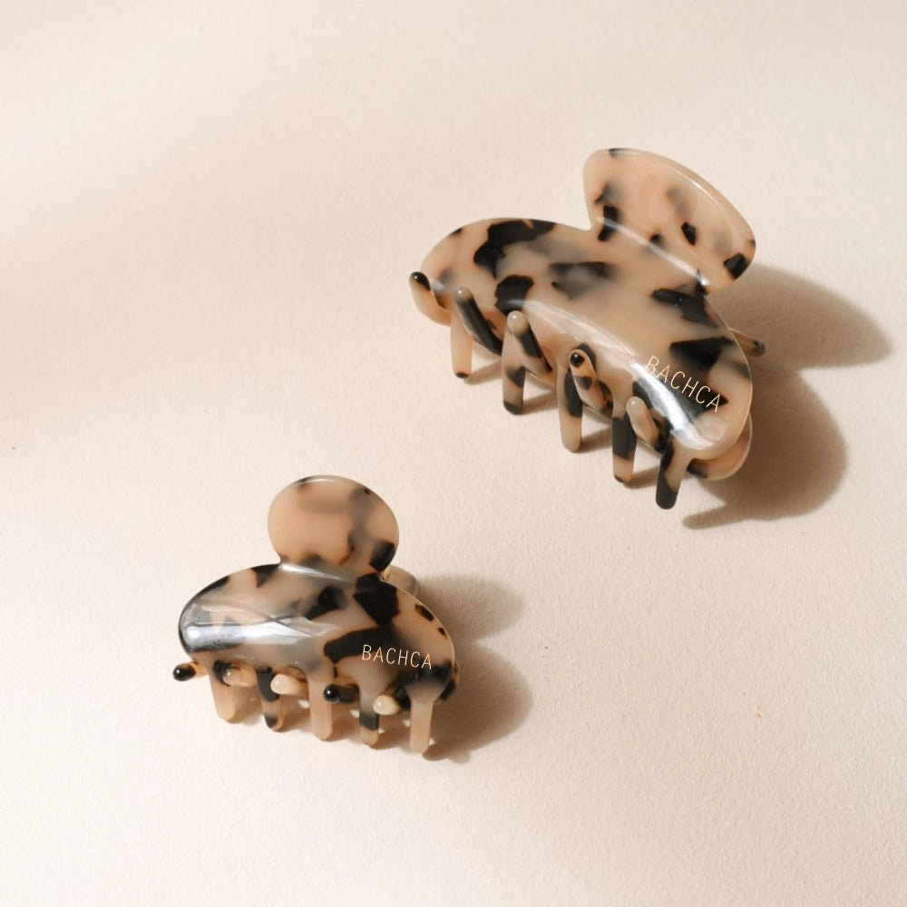 Tortoiseshell Claw Clip in small and classic sizes with packaging on a light pink background