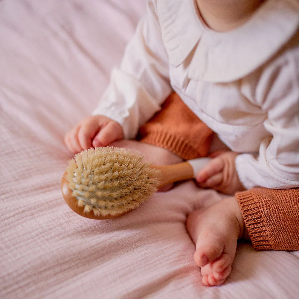 The Bachca fine and fragile hair brush being used on a child’s hair.