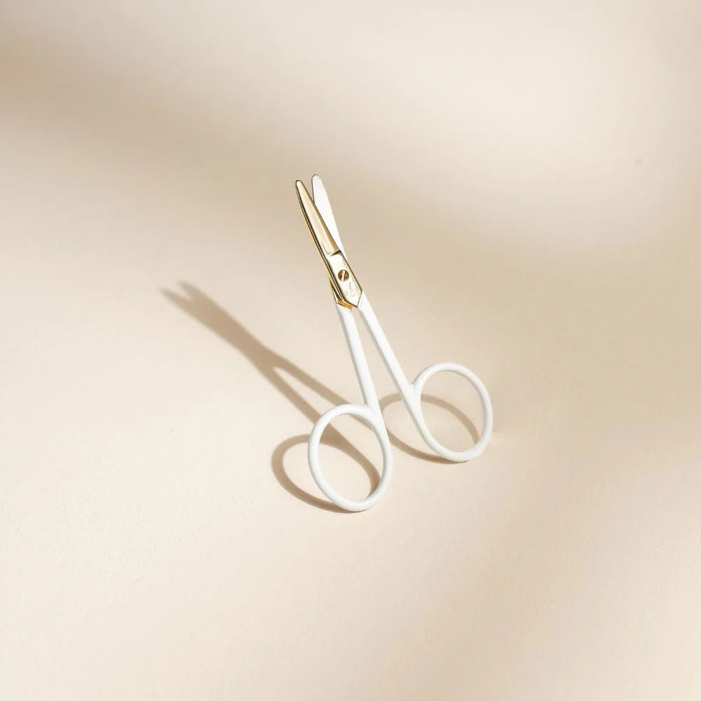 Baby Nail Scissors Against Beige Background 