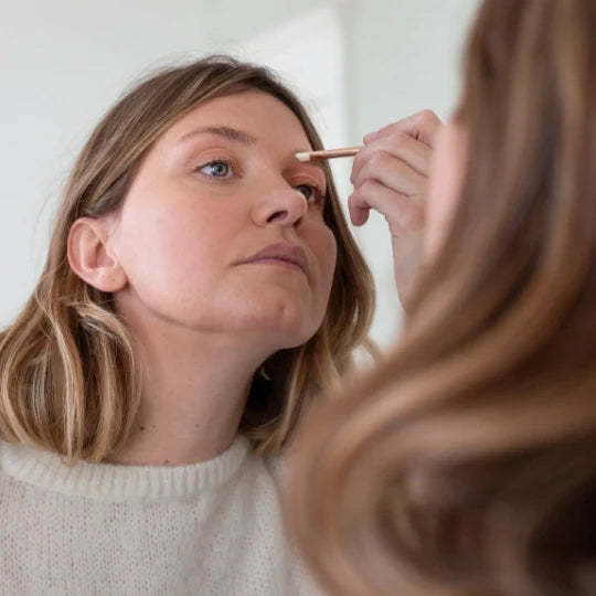 Woman Using Eyebrow and Eyeliner Brush on Eyebrows 