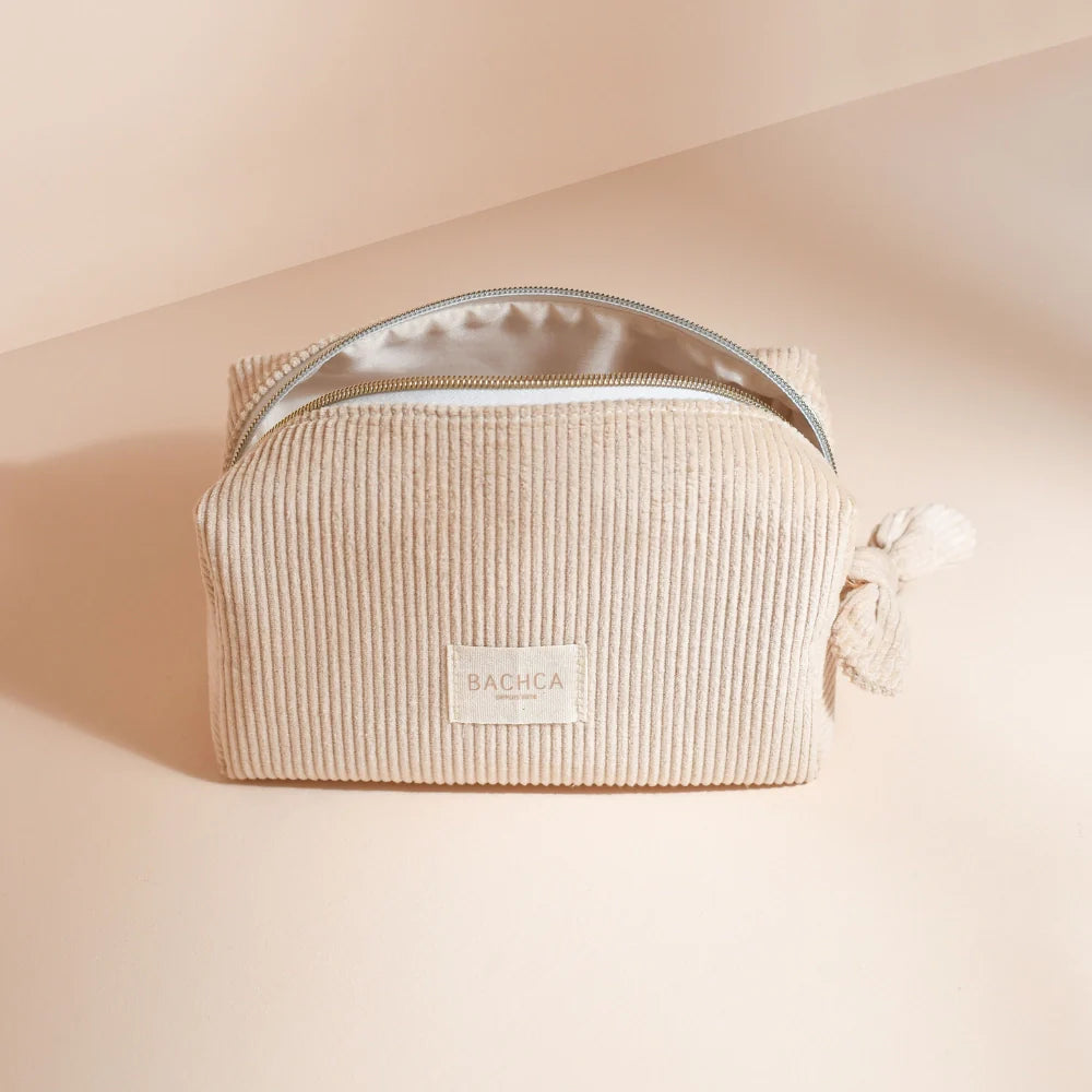 BACHCA beige velvet makeup pouch open, cream background with soft natural light.