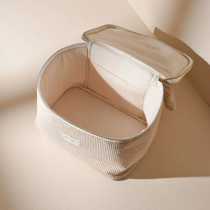 Interior of BACHCA velvet vanity open, top-down view, soft light on cream background.