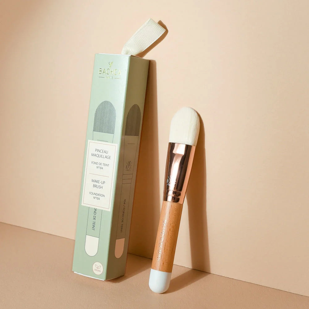 Bachca Smooth Foundation Brush leaning against beige wall 